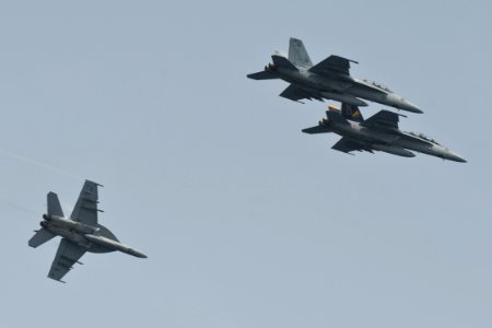 US Navy 100703-N-7317W-019 F-A-18F Super Hornets assigned to the Swordsmen of Strike Fighter Squadron (VFA) 32 fly by the aircraft carrier USS Harry S. Truman (CVN 75) in formation during a change of command ceremony