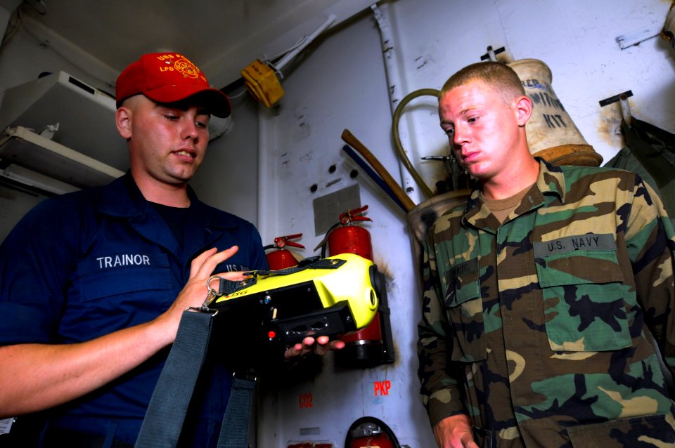 US Navy 100708-N-3154P-005 Damage Control Fireman Robert Trainor familiarizes Quartermaster Seaman Shane Perritt on the usage of the naval firefighting thermal imager