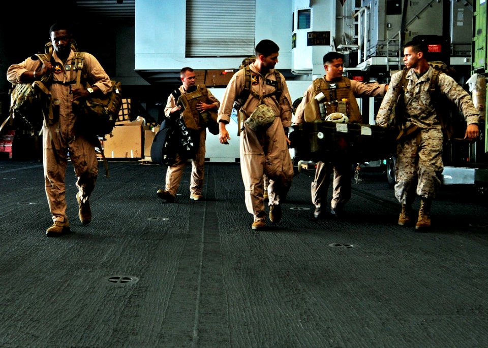 US Navy 100708-N-2908M-016 Marines transport medical supplies through the hangar bay of USS Kearsarge (LHD 3)
