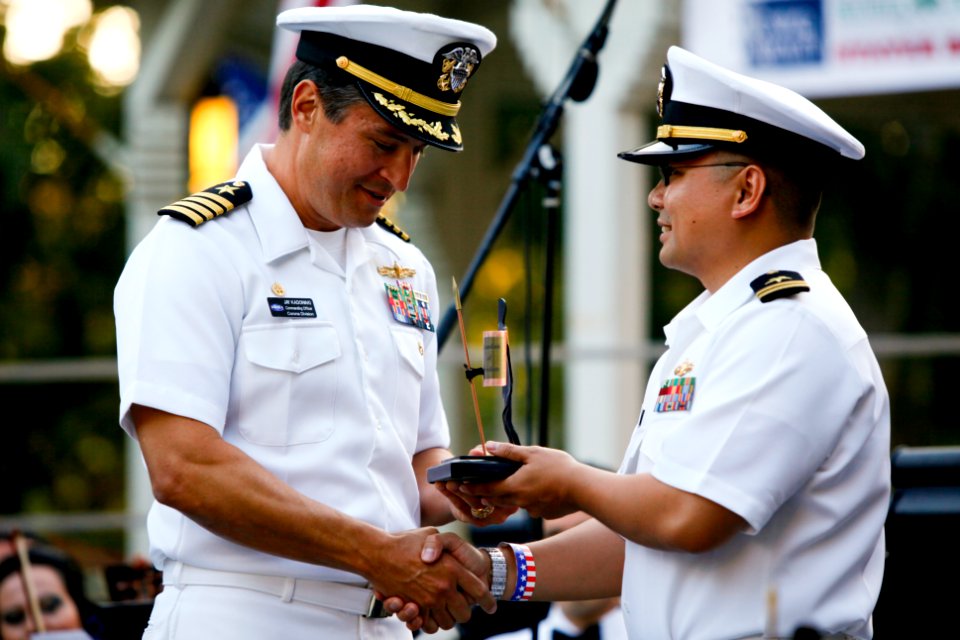 US Navy 100704-N-8863V-530 Capt. Jay Kadowaki, commanding officer of Naval Surface Warfare Center (NSWC), Corona Division, presents Fleet Liaison Officer Lt. Tin Tran with the community Guardian of Freedom award