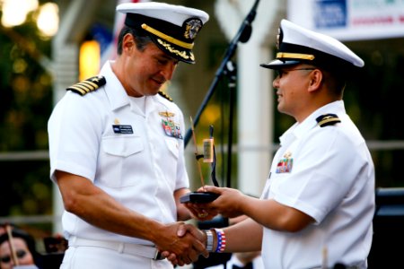 US Navy 100704-N-8863V-530 Capt. Jay Kadowaki, commanding officer of Naval Surface Warfare Center (NSWC), Corona Division, presents Fleet Liaison Officer Lt. Tin Tran with the community Guardian of Freedom award