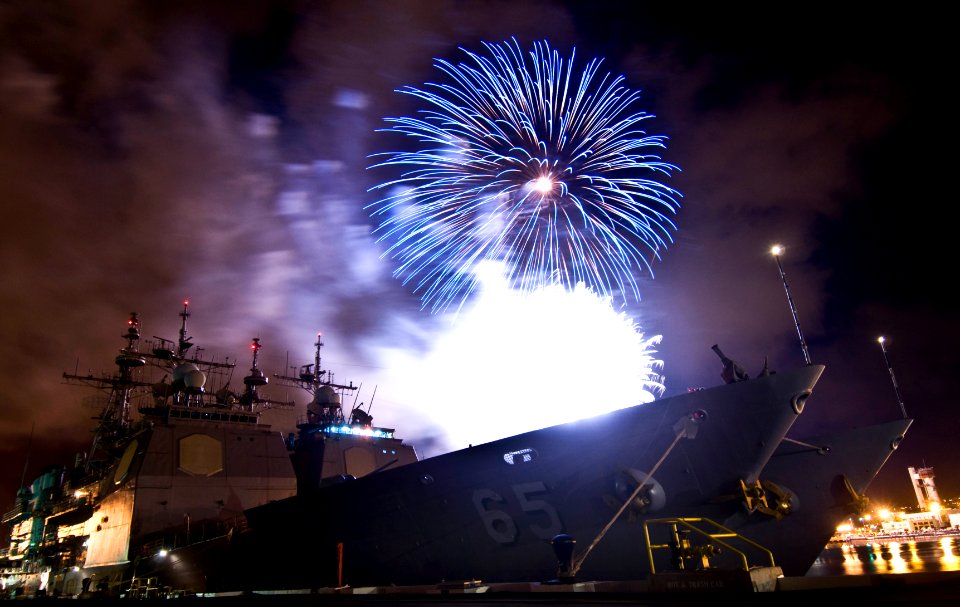US Navy 100704-N-7498L-530 Fireworks at the Joint Base Pearl Harbor-Hickam (JBPHH) explode over two Aegis-class cruisers, USS Chosin (CG 65) and USS Lake Erie (CG 70)