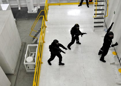 US Navy 100708-N-7643B-099 Two Republic of Singapore Navy sailors advance on a suspect during a simulated boarding exercise in the boarding and search trainer