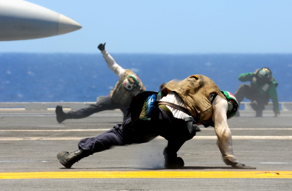 US Navy 100707-N-3659B-159 A trouble shooter braces himself as an EA-6B prowler launches from USS Ronald Reagan (CVN 76)