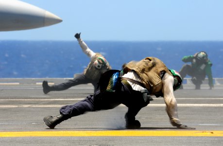 US Navy 100707-N-3659B-159 A trouble shooter braces himself as an EA-6B prowler launches from USS Ronald Reagan (CVN 76)
