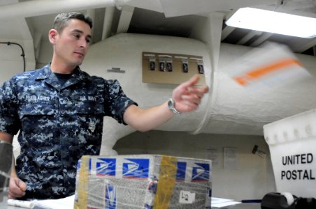 US Navy 100709-N-2918M-049 Logistics Specialist Seaman Noel Gallager sorts mail in the post office aboard USS Nimitz (CVN 68)