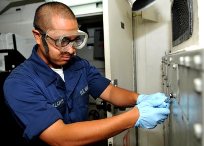 US Navy 100707-N-2013O-068 Information Systems Technician Seaman Rex Bagalawis, from San Diego, performs maintenance