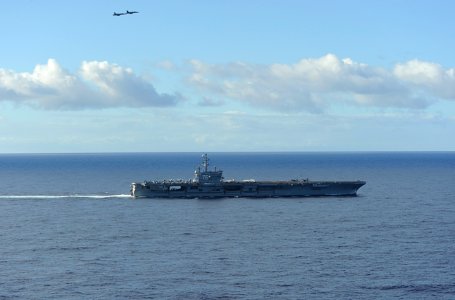 US Navy 100706-N-9500T-598 Two F-A-18 Hornets fly over USS Ronald Reagan (CVN 76) after she departed Pearl Harbor to participate in Rim of the Pacific (RIMPAC) 2010 exercises