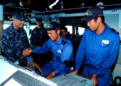 US Navy 100712-N-3570S-213 Vice Adm. Richard W. Hunt shakes hands with the lead helmsman on the bridge aboard JS Akebono (DD 108)