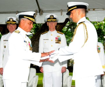 US Navy 100709-N-3666S-026 A Sailor presents Rear Adm. Michael Giorgione with a flag during a change of command ceremony at Commander, U.S. Pacific Fleet Headquarters