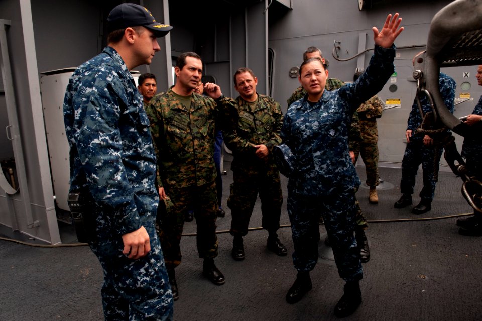 US Navy 100709-N-5319A-076 Aviation Boatswain's Mate (Fuel) Airman Karina Allain translates for Peruvian senior officers while touring the boat deck aboard USS New Orleans (LPD 18)