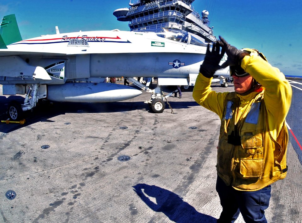 US Navy 100712-N-2953W-176 Sailor signals aircraft into position aboard USS Carl Vinson