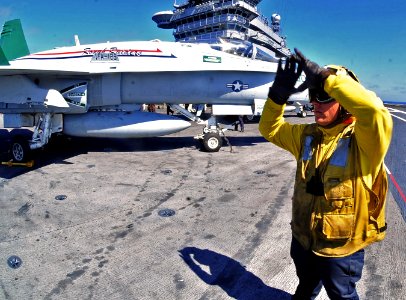 US Navy 100712-N-2953W-176 Sailor signals aircraft into position aboard USS Carl Vinson