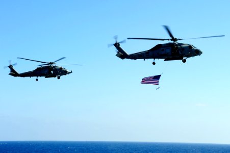 US Navy 100709-N-6604E-390 SH-60F Sea Hawk helicopters assigned to the Nightdippers Helicopter Anti-submarine Squadron (HS) 5 fly above the aircraft carrier USS Dwight D. Eisenhower (CVN 69)