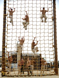 US Navy 100708-N-0775Y-015 Sailors assigned to Fleet Combat Camera Group Pacific, navigate the rope climb portion of the obstacle course at the Naval Special Warfare Center in Coronado, Calif photo