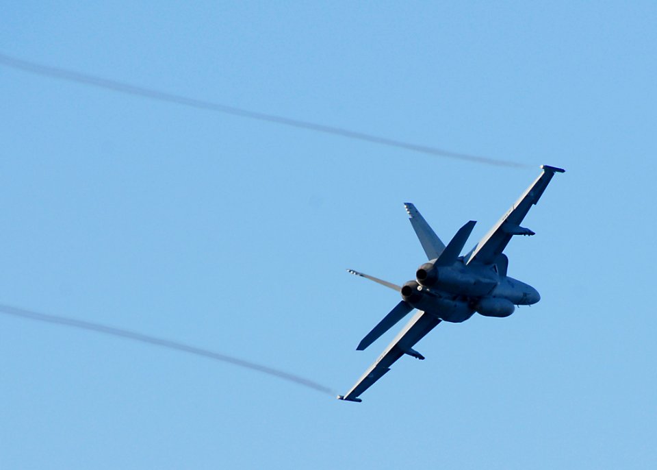 US Navy 100708-N-8283S-055 An F-A 18 Super Hornet performs a low flyby above USS Boxer (LHD 4)
