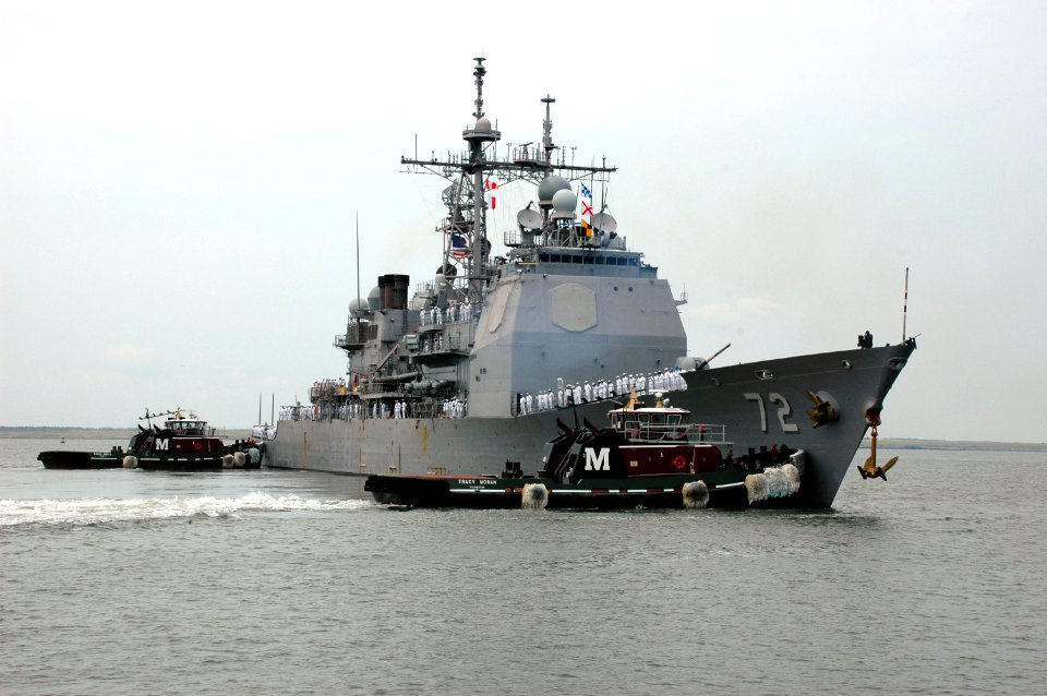 US Navy 100708-N-5292M-691 Tug boats direct the guided-missile cruiser USS Vella Gulf (CG 72) away from the pier at Naval Station Norfolk