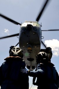 US Navy 100709-O-0000S-003 Cpl. Dale Sinclair, left, and Cpl. Alex Noel stand by to recover a CH-124 Sea King helicopter aboard the Canadian Navy estroyer (HMCS) Algonquin (DDG 283)