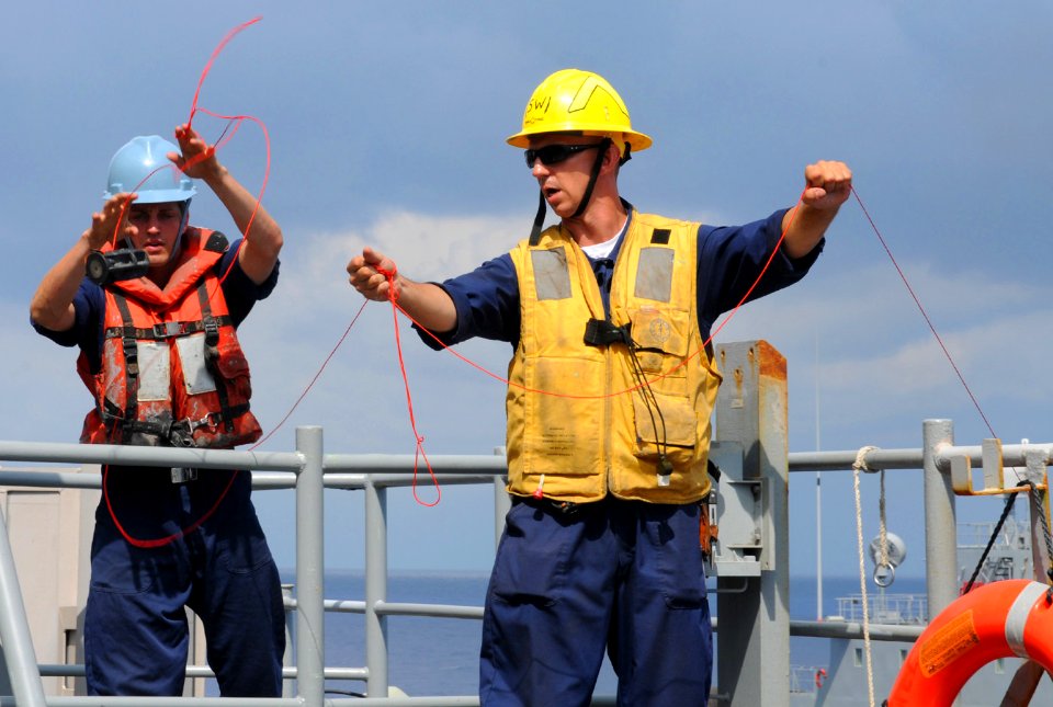 US Navy 100708-N-8069G-070 Sailors work the lines during a replenishment at sea aboard USS Carter Hall (LSD 50)