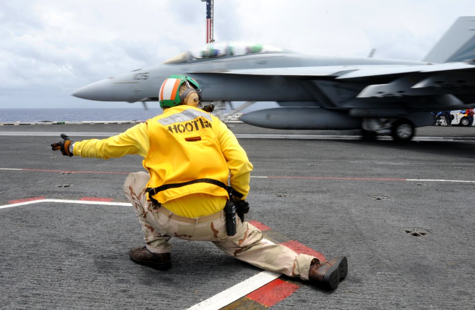 US Navy 100710-N-3659B-212 Lt. Cmdr. Robert Wackerman gives the signal for an F-A-18F Super Hornet assigned to the Black Knights