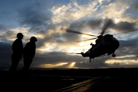 US Navy 100709-N-6477M-377 Sailors observe as an Australian Royal Navy SK-50 helicopter takes off from USS Cleveland (LPD 7)