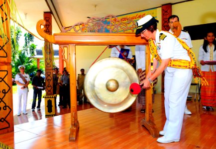 US Navy 100713-N-6410J-269 Capt. Lisa M. Franchetti, commander of Pacific Partnership 2010, bangs a gong during the opening ceremony in Indonesia photo