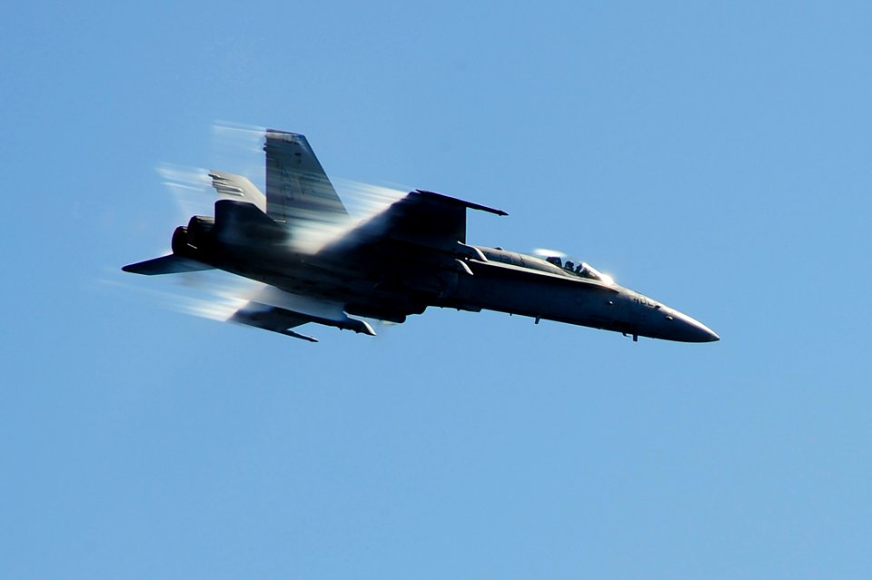 US Navy 100709-N-6604E-322 An F-A-18C Hornet assigned to the Wildcats of Strike Fighter Squadron (VFA) 131 breaks the sound barrier during an air power demonstration above the aircraft carrier USS Dwight D. Eisenhower (CVN 69)