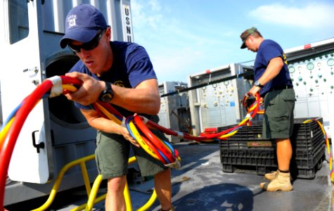 US Navy 100712-N-9769P-353 Navy Diver 1st Class Joel Sharp, left, assigned to Mobile Diving and Salvage Unit (MDSU) 2