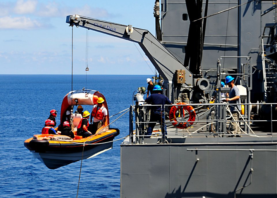 US Navy 100711-N-3446M-178 Merchant mariners assigned to the Military Sealift Command dry cargo and ammunition ship USNS Amelia Earhart (T-AKE 6) hoist a lifeboat and crew from the targets department of Commander Fleet Activiti