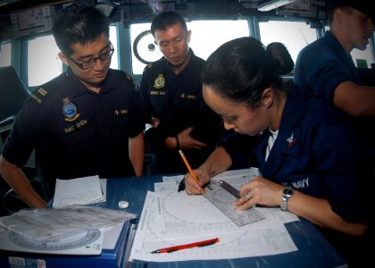 US Navy 100710-N-0995C-072 Operations Specialist 2nd Class Jessica Proudfoot plots courses on a maneuvering board with Republic of Singapore Navy officers on the bridge of the guided-missile destroyer USS Chung-Hoon (DDG 93)