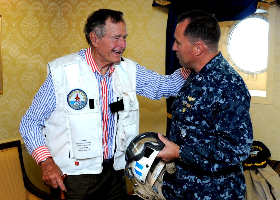 US Navy 100714-N-6632S-109 Former President George H.W. Bush speaks with Cmdr. William Pennington, executive officer of the aircraft carrier USS George H.W. Bush (CVN 77)