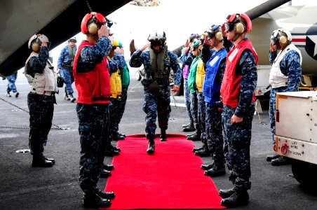 US Navy 100711-N-3659B-113 Vice Adm. Richard W. Hunt salutes while passing through rainbow sideboys aboard USS Ronald Reagan (CVN 76)
