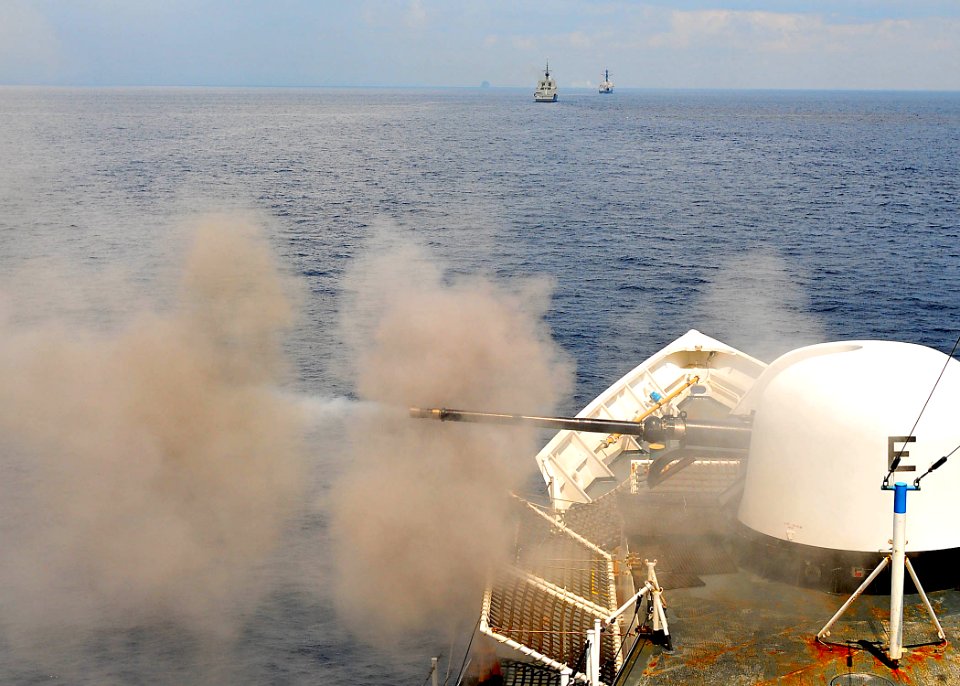 US Navy 100713-N-7643B-046 U.S. Coast Guard fires weapon as part of CARAT Singapore 2010