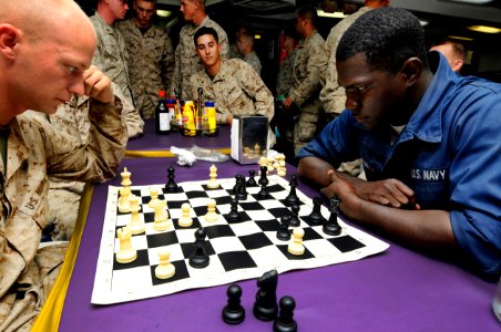 US Navy 100712-N-3154P-022 Sgt. Shane Worley and Boatswain's Mate Seaman Nathaniel Bracewell play chess on the mess decks of the amphibious transport dock USS Ponce (LPD 15)