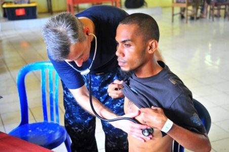 US Navy 100715-N-5207L-221 Lt. Cmdr. Ira Nash, embarked aboard the Military Sealift Command hospital ship USNS Mercy (T-AH 19), listens to an Indonesian man's heartbeat photo