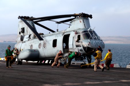 US Navy 100714-N-5319A-013 Sailors aboard the amphibious transport dock ship USS New Orleans (LPD 18) push a Marine Corps CH-46 Sea Knight helicopter out of the hangar bay