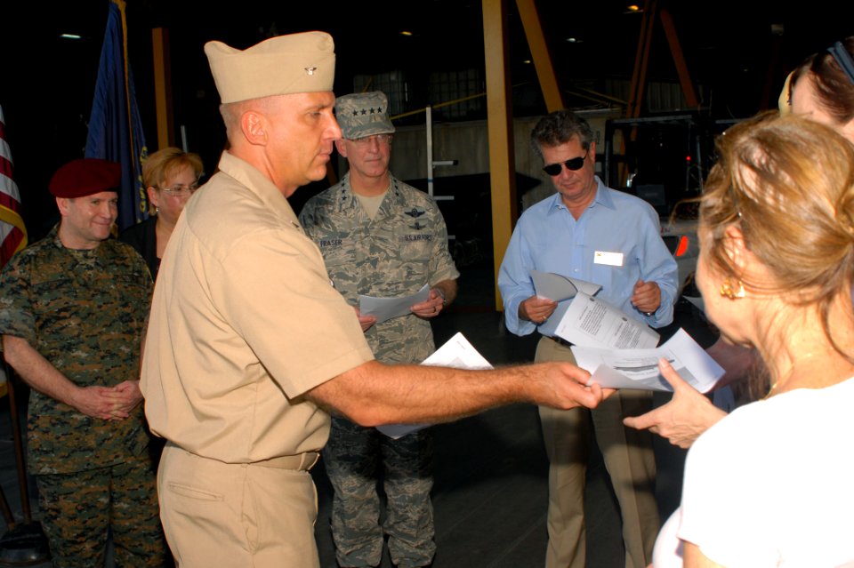 US Navy 100715-N-4971L-017 Capt. Kurt Hedberg, left, mission commander of Southern Partnership Station 2010, hands out information pamphlets