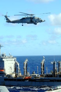US Navy 100715-N-7605J-008 An HH-60H Sea Hawk helicopter assigned to Helicopter Anti-Submarine Squadron (HS) 4 transports cargo to the aircraft carrier USS Ronald Reagan (CVN 76)