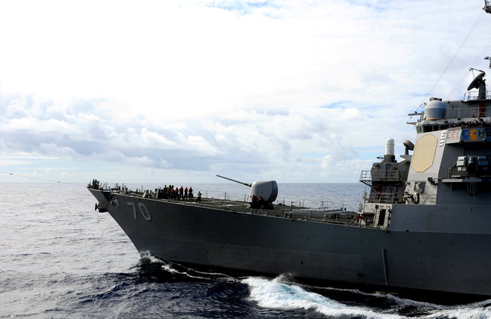 US Navy 100713-N-3659B-002 Sailors on the bow of USS Hopper (DDG 70) pull in the phone and distance line at the conclusion of a fueling at sea