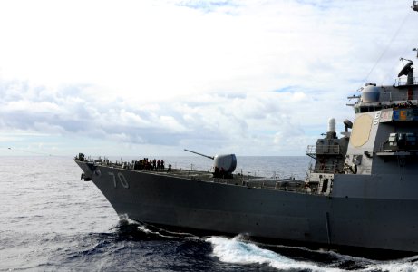 US Navy 100713-N-3659B-002 Sailors on the bow of USS Hopper (DDG 70) pull in the phone and distance line at the conclusion of a fueling at sea photo