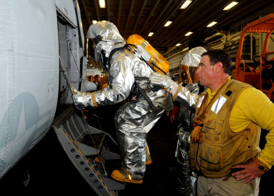US Navy 100715-N-3265K-025 Chief Warrant Officer Patrick J. Halinski instructs the crash and salvage fire team during a drill aboard the multipurpose amphibious assault ship USS Iwo Jima (LHD 7)