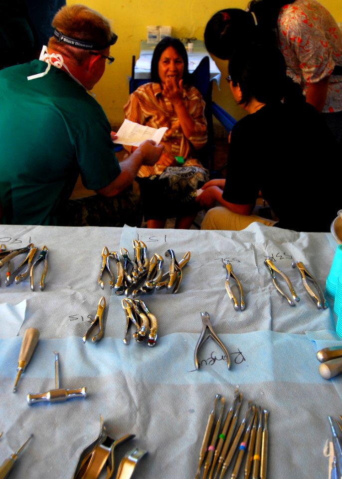 US Navy 100714-N-4044H-072 Canadian Forces Maj. Dean Gresko listens as a patient points to a tooth giving her pain during a Pacific Partnership 2010 dental civic action program