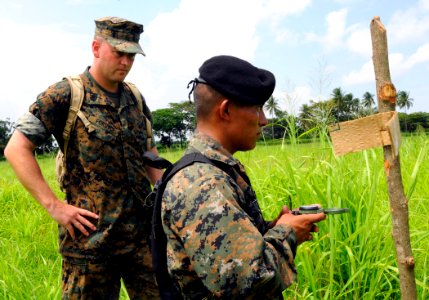 US Navy 100716-N-9643W-592 Sgt. Chad Fordyce observes as a Guatemalan marine uses a compass to find pre-determined points during the Marine Corps subject matter expert exchange photo