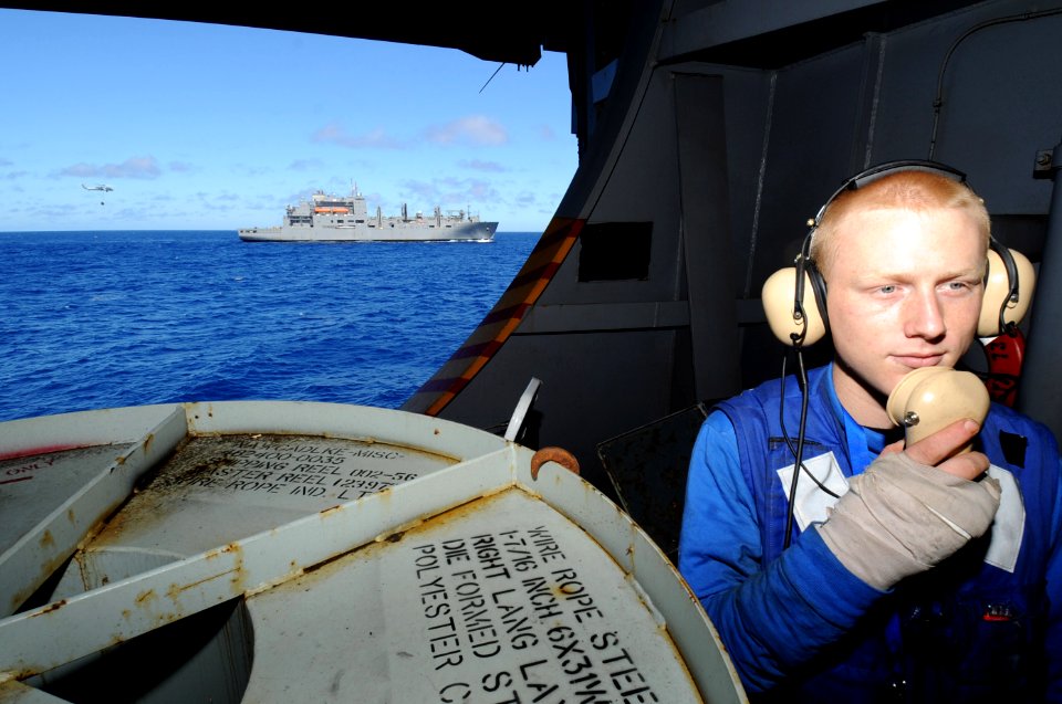US Navy 100715-N-7191M-029 Aviation Boatswain's Mate (Handling) Devin Traxler, from Turlock, Ca., communicates on a sound-powered phone in the hanger bay aboard the aircraft carrier USS George Washington (CVN 73)