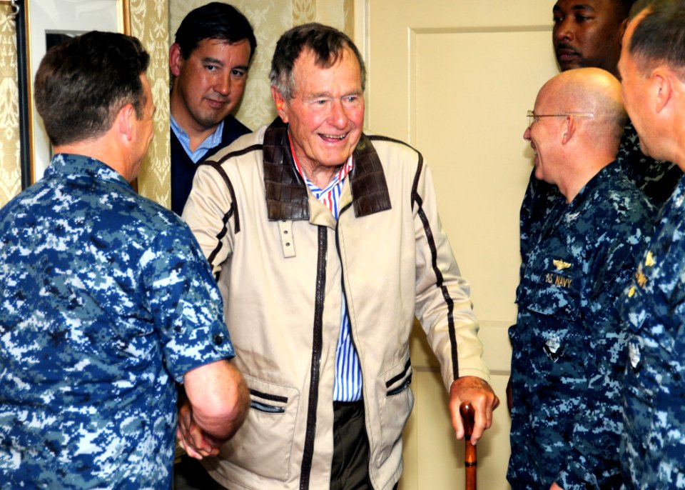US Navy 100714-N-6632S-058 Former President George H.W. Bush shakes hands with crew members aboard the aircraft carrier that bears his name, USS George H.W. Bush (CVN 77)