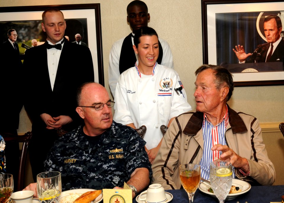 US Navy 100714-N-7908T-034 Former President George H.W. Bush speaks with Culinary Specialist 2nd Class Lessa M. Zilempe, assigned to the supply department aboard the aircraft carrier USS George H.W. Bush (CVN 77)