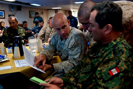 US Navy 100717-N-5319A-019 Col. Gary Johnsto and Peruvian Col. Gerardo Gervasi discuss details during a confirmation brief in the wardroom of USS New Orleans (LPD 18)