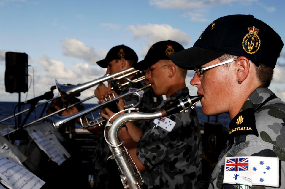 US Navy 100714-N-6477M-193 Able Seamen Musician Ellen Zyla, right, Tony Frantz and Fletcher Mitchell perform an evening concert for ship's company on the flight deck of USS Cleveland (LPD 7)