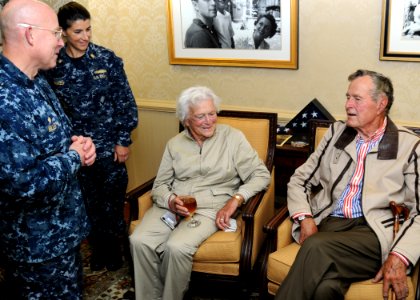 US Navy 100714-N-6632S-071 Former President George H.W. Bush and his wife, Barbara, talk with Capt. Chip Miller, commanding officer of the aircraft carrier USS George H.W. Bush (CVN 77), in the captain's in port cabin