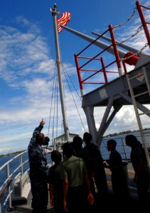 US Navy 100714-N-9706M-153 Boatswain's Mate 2nd Class Baltazar Salinas explains the relationship of bow lights and navigation safety to cadets from Feydhoo High School in the Maldives